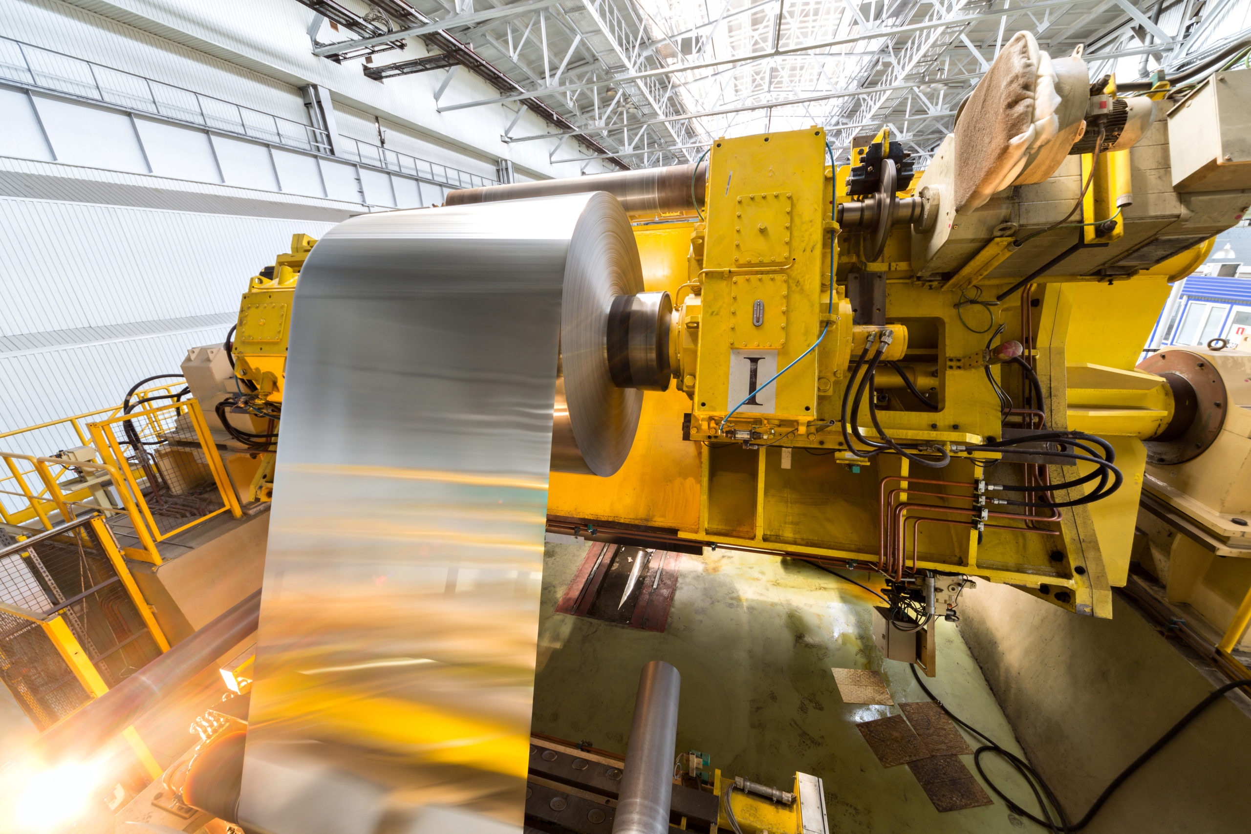 Roll of sheet metal being rolled onto a factory machine