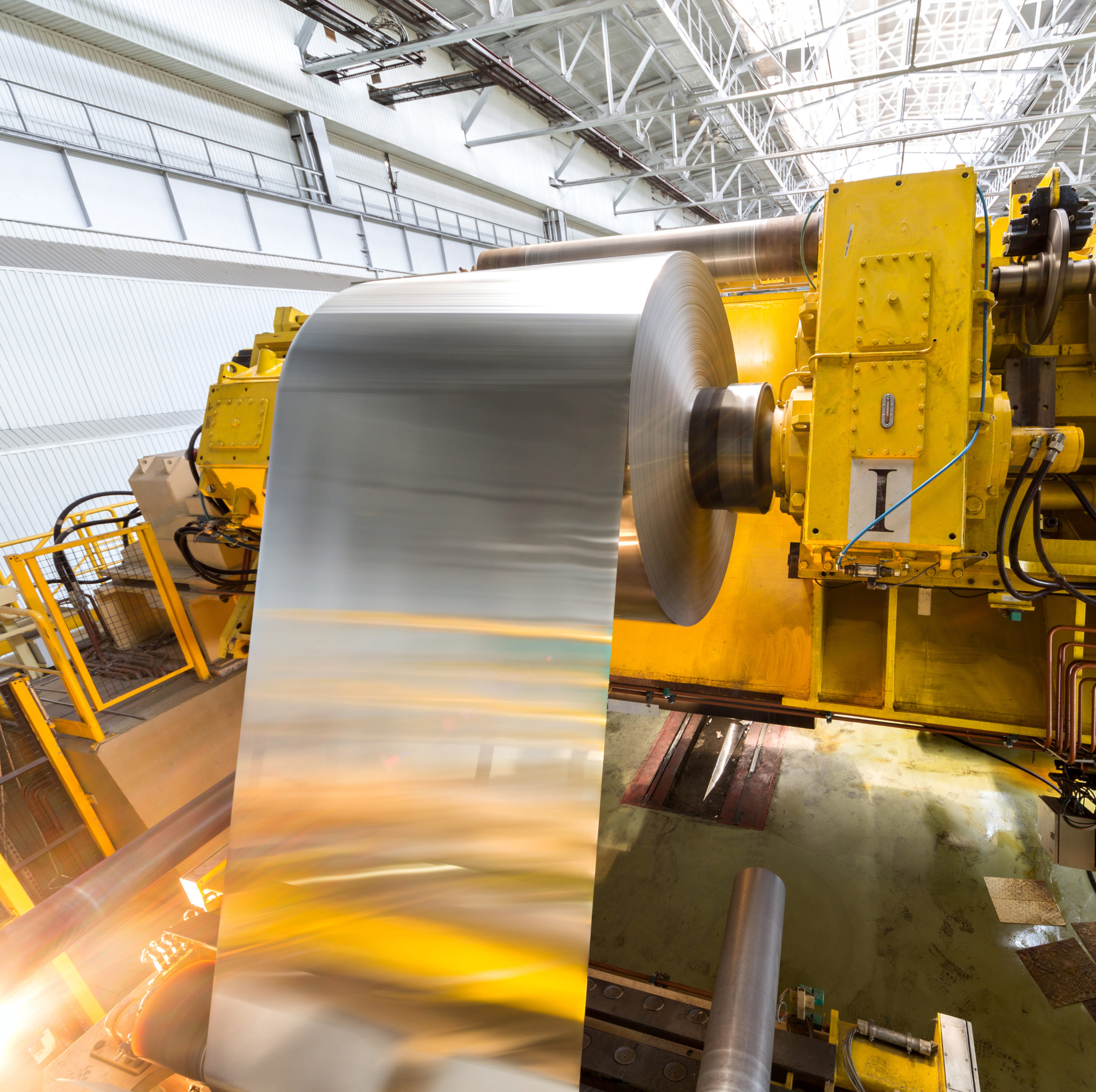 Roll of sheet metal being rolled onto a factory machine